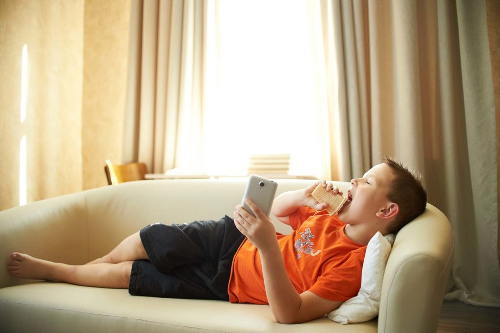 Child eating on the couch