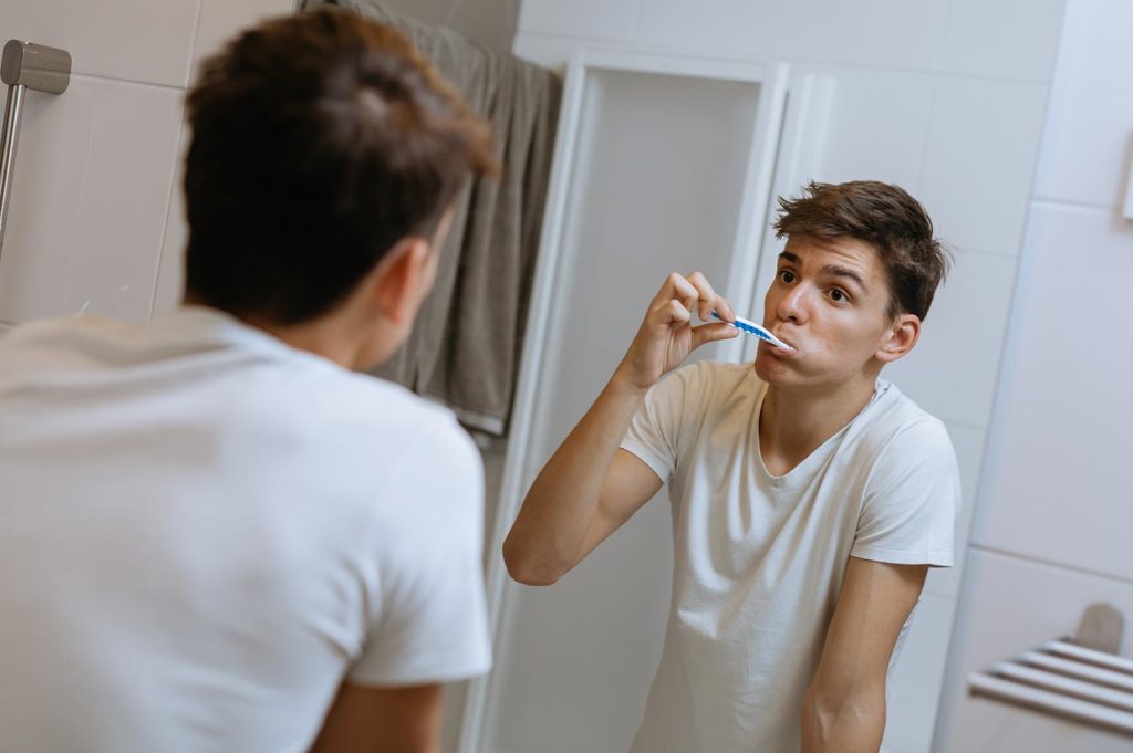 Teenager washing teeth